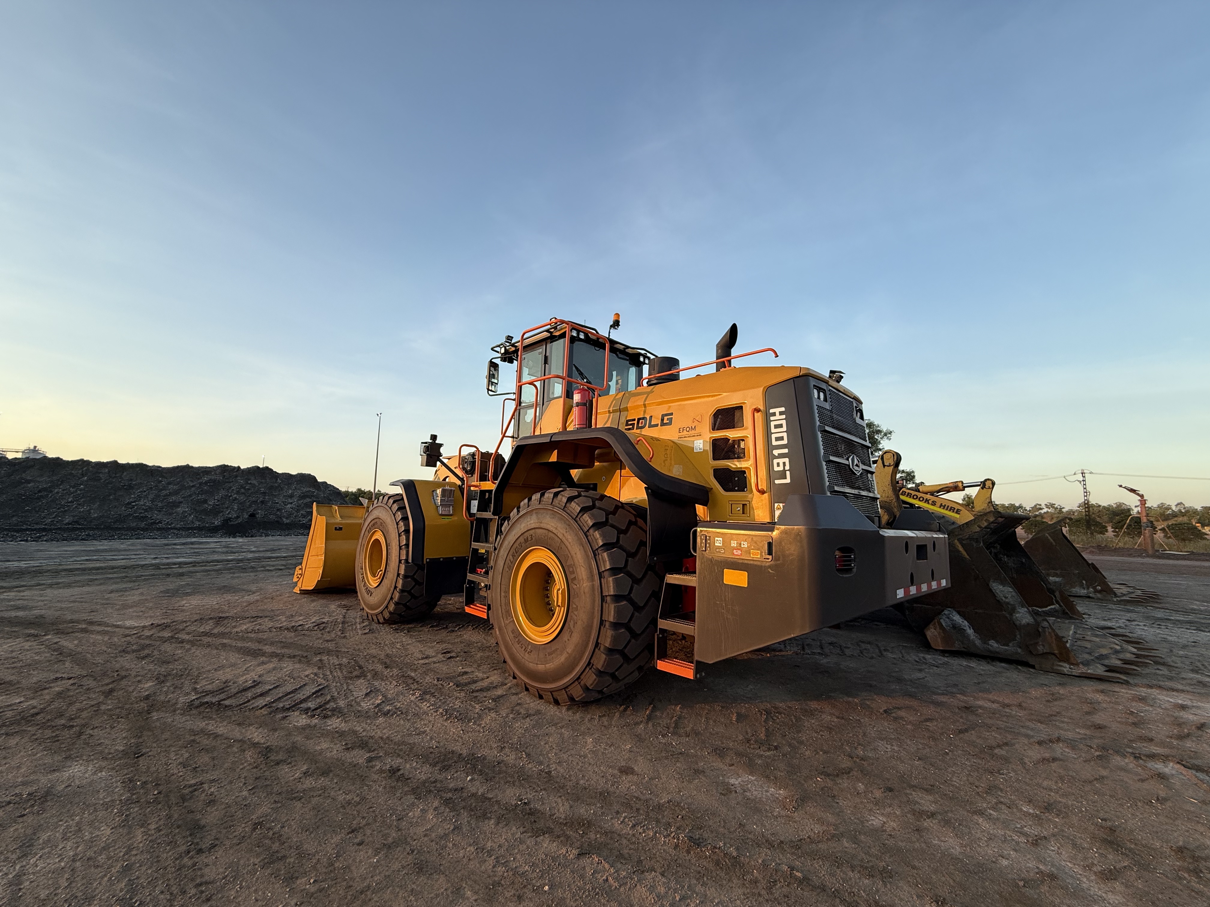 SDLG L9100 wheel loader working a stockpile